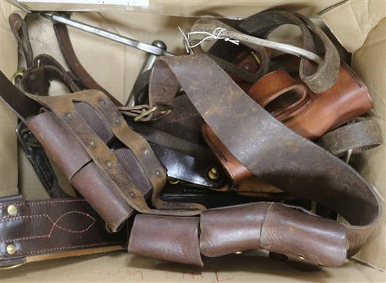 A group of leather bridles, stirrups and leather ammunition pouches